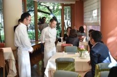 テーブルをまわり参加者にあいさつする佐藤伸一シェフ