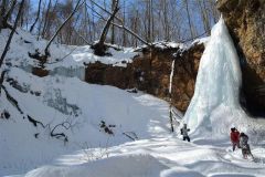 氷の滝は浸食されてできた谷間の最奥にある。横にも雪をかぶった氷壁あった