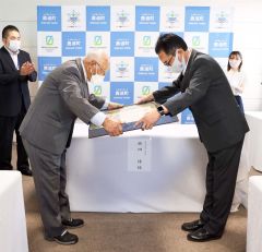 喜井町長（右）から伝達される植田さん（左）