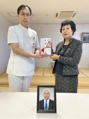 一条院長（左）に１０００万円の目録を手渡す高橋前町長の妻の照子さん