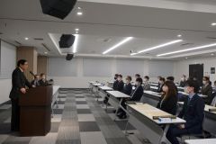 職員を前に来年への決意を述べる川田会頭（左）