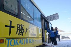 貨物の積み降ろし用に設けた開口部を開け、貨物を下ろす関係者（７日午前９時ごろ、十勝バス広尾営業所で）