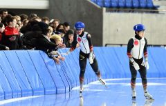 【男子マススタート】３位に入賞し、リンクサイドの関係者とタッチを交わす新海大輝（中央）。右は優勝を飾った渕上結太（