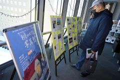 館内に設置された映画の関連記事がまとめられたボードを目にする来館者