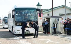 式典後、代行バスの運転士（左）に花束を贈る浜田正利新得町長（右）＝３１日、ＪＲ新得駅前で。金野和彦撮影