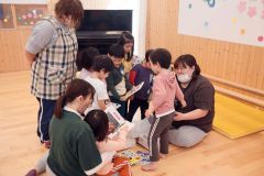 寄贈された絵本をさっそく手に取る園児たち