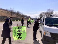 安全運転を呼び掛ける資料を手渡す参加者たち