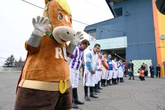 帯広競馬場の入場門で来場者を迎える騎手ら（１９日、須貝拓也撮影）