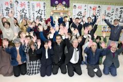 支援者たちと一緒に当選を喜ぶ田中氏（前列右から４人目）。妻朋子さん（同列右から５人目）。北藤選対本部長（同列右から３人目）＝２１日、午後９時４５分ごろ、広尾町内の選挙事務所で。金野和彦撮影）