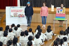 演劇の前に紙芝居で防災について説明する桜花分団とそれを聞く子どもたち（２４日１０時５０分、帯西幼稚園）