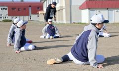 西田社長から腰回りのウオーミングアップを学ぶ生徒ら