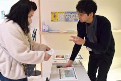 チケット引き換える町民（左）
