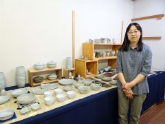 十勝の自然と土の温もりを表現した器が並ぶ会場と青木さん