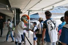 ファイターズのマスコット、Ｂ・Ｂと握手をする参加者（村広報提供）