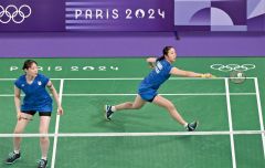【女子ダブルス予選ラウンドグループＡ・インドネシア戦】第１ゲーム、シャトルをひろう永原和可那（右）。左は松本麻佑（金野和彦撮影）