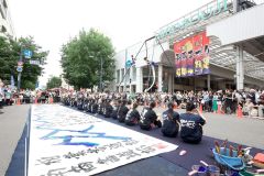 日高山脈をイメージした大型トラスで華麗な技を披露したエアリアルアーティストの長すみ絵さんの演技に歓声を上げる来場者ら（平栗玲香通信員撮影）