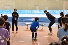 子どもたちに滑走時のフォームについて指導する野々村太陽選手(右)と山根佳子選手(左)=金野和彦撮影