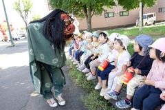 獅子舞を怖がる子どもたち(24日午前10時20分ごろ、助川かおる通信員)