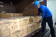 コンテナから年賀はがきが入った段ボール箱を下ろす局員(3日午前9時ごろ、須貝拓也撮影)