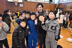 制服や作業着の着用体験を楽しむ児童